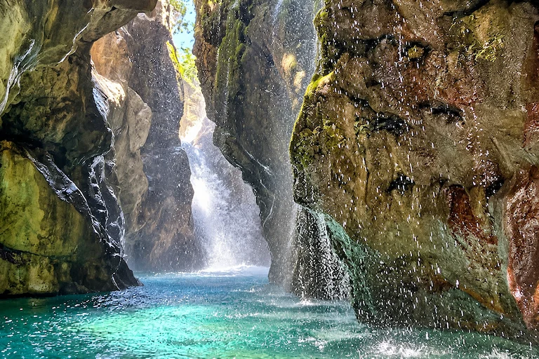 Towering canyon walls and freshwater waterfalls of Kourtaliotiko Gorge